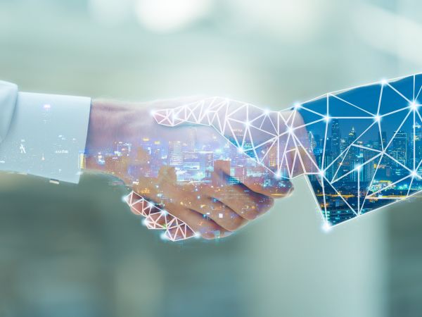 Händeschütteln zwischen digitaler und realer Hand